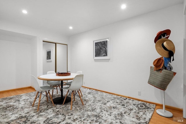 dining space with wood-type flooring