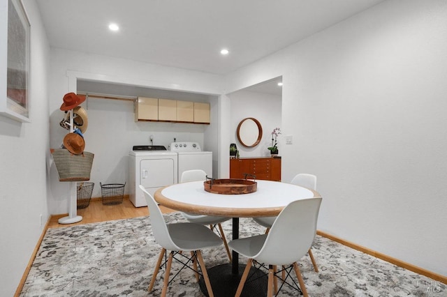 dining space with washer and dryer and light wood-type flooring