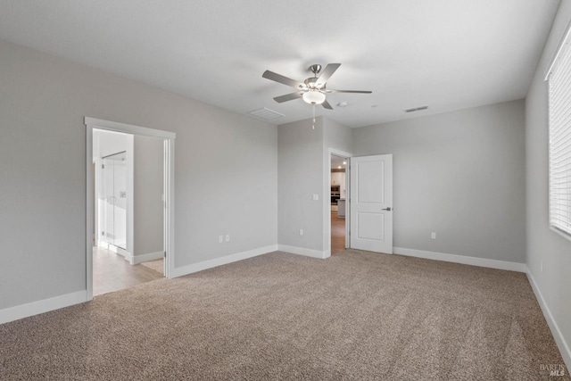 unfurnished room featuring light carpet and ceiling fan