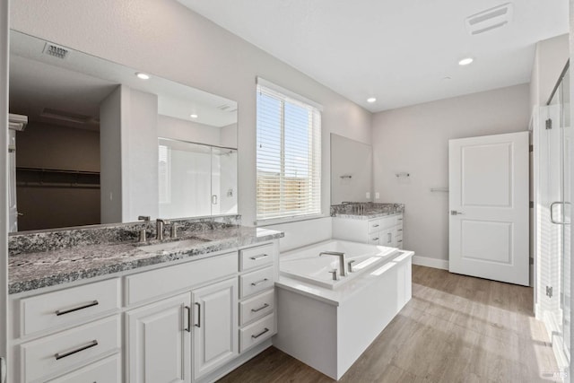 bathroom featuring vanity, hardwood / wood-style floors, and independent shower and bath