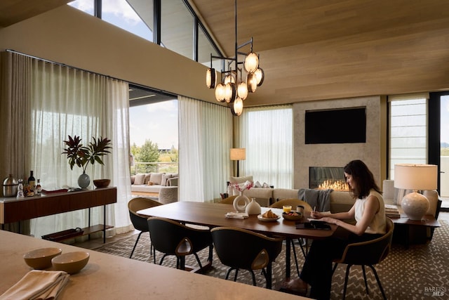 dining room with a large fireplace and a chandelier