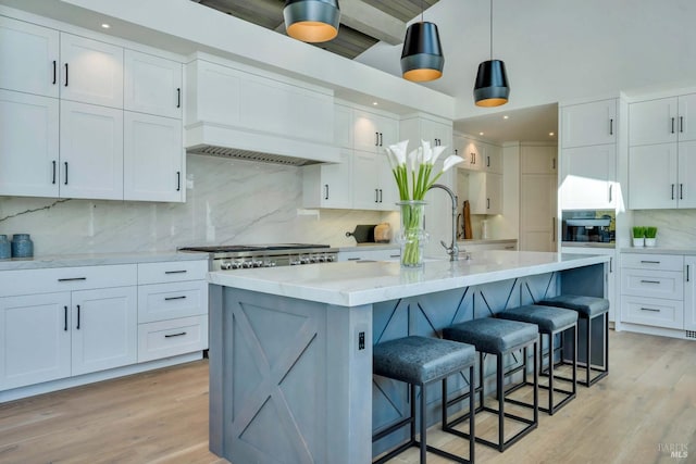 kitchen featuring white cabinetry, backsplash, and light hardwood / wood-style floors