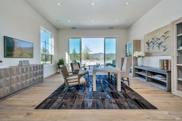 dining area featuring recessed lighting, a mountain view, and wood finished floors