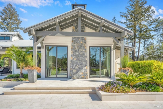 view of exterior entry featuring stone siding
