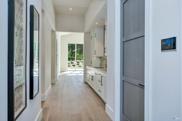 hallway featuring light hardwood / wood-style floors and sink