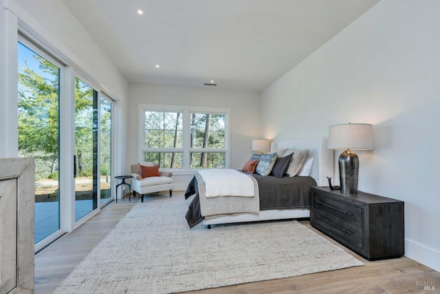 bedroom with light wood-style floors, recessed lighting, baseboards, and access to exterior