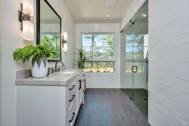 bathroom featuring vanity and an enclosed shower