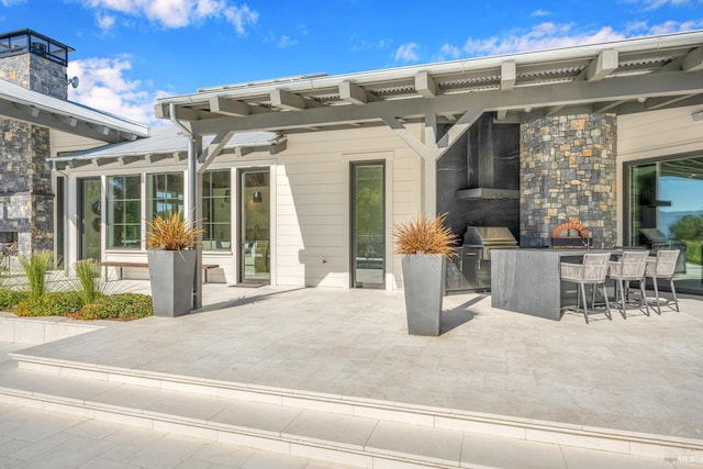 view of patio / terrace featuring a grill and a pergola