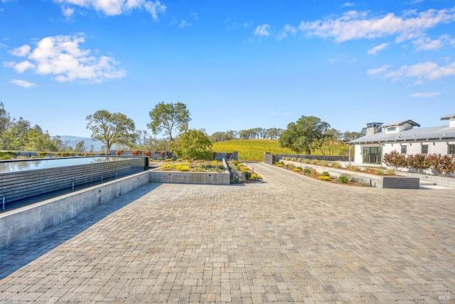 view of property's community featuring a water view and a patio