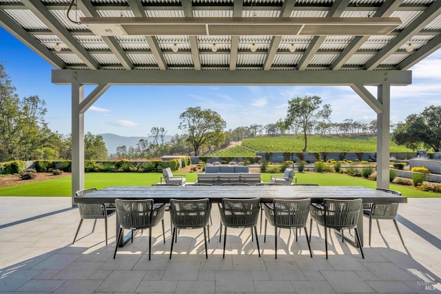 view of patio / terrace featuring a pergola and a mountain view