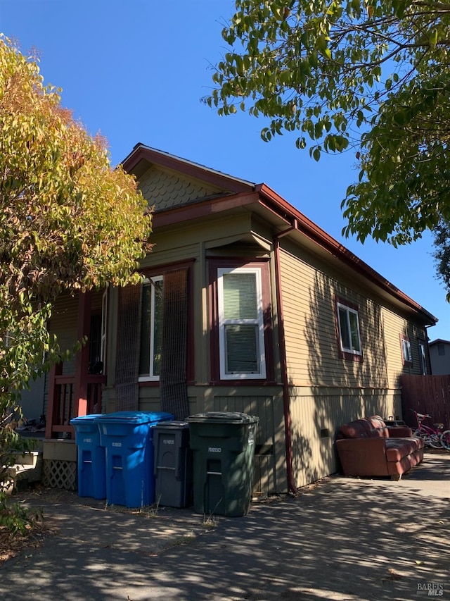 view of property exterior with a patio area