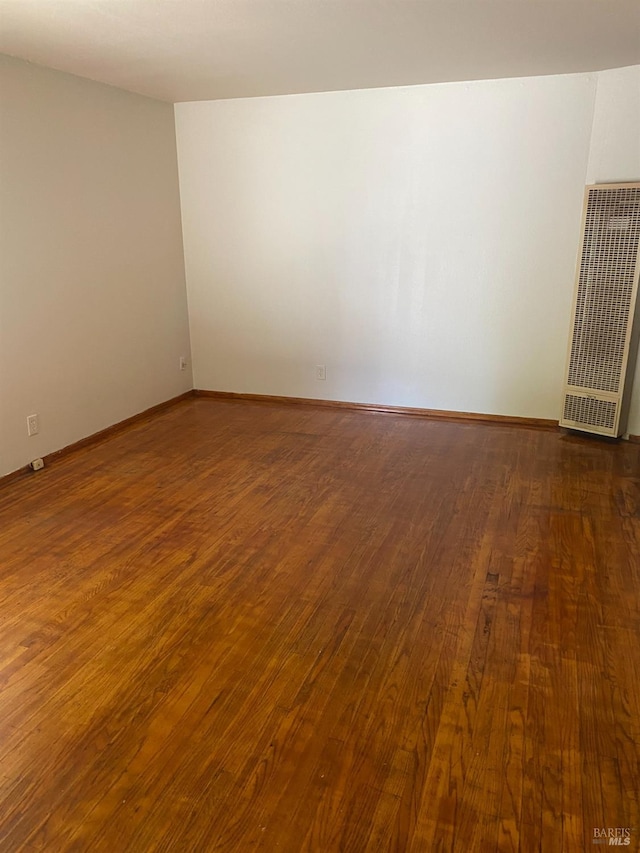 empty room with dark wood-type flooring