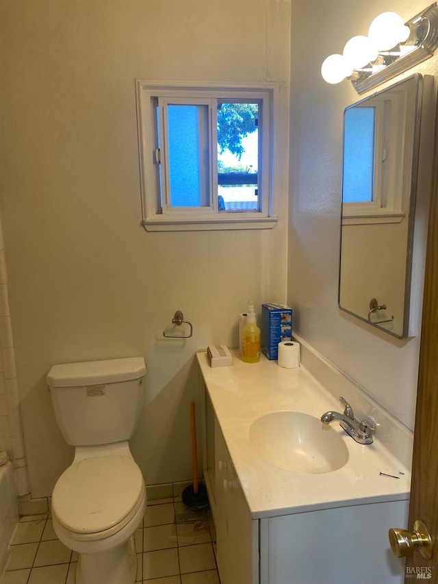 bathroom with vanity, toilet, and tile patterned floors