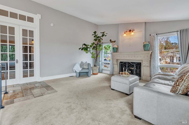 living room featuring lofted ceiling, french doors, and carpet flooring