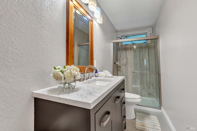 bathroom featuring vanity, toilet, and walk in shower