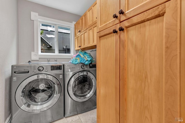 washroom featuring washing machine and dryer and cabinets