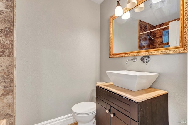 bathroom with vanity, toilet, and a shower