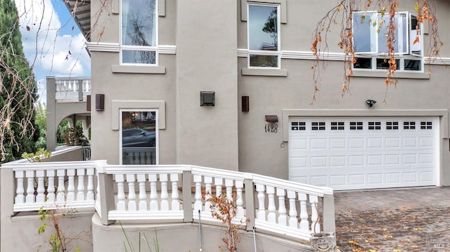 exterior space with a balcony and a garage