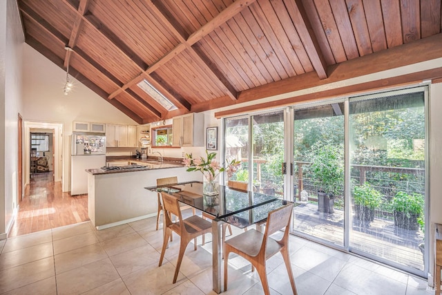 dining space with wood ceiling, high vaulted ceiling, light hardwood / wood-style flooring, beamed ceiling, and sink