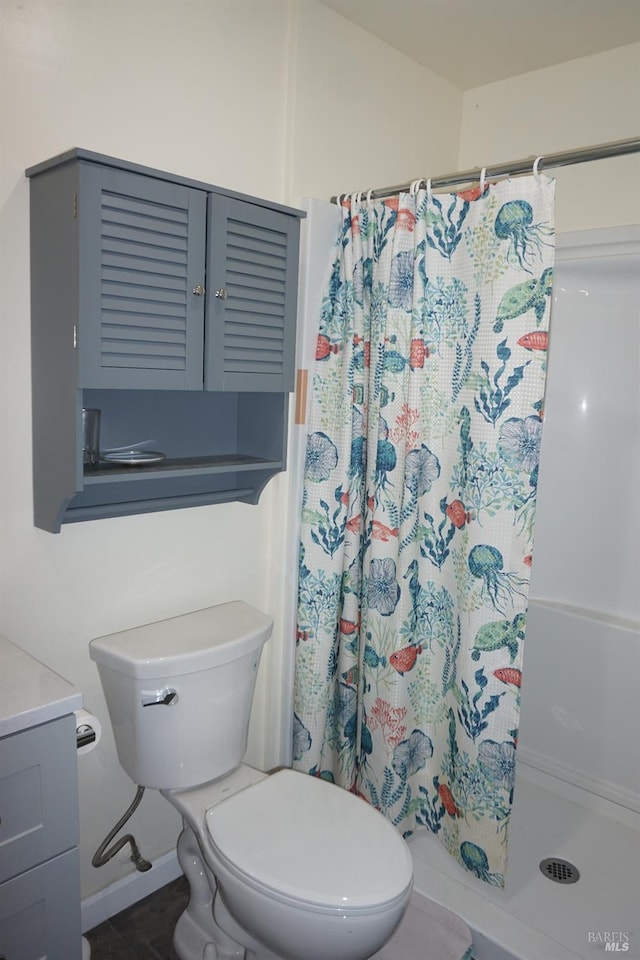 bathroom featuring vanity, a shower with curtain, and toilet