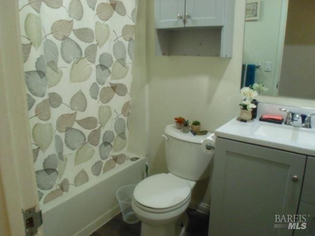 full bathroom featuring vanity, shower / tub combo, and toilet