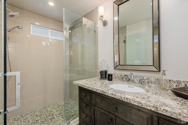 bathroom featuring vanity and a tile shower