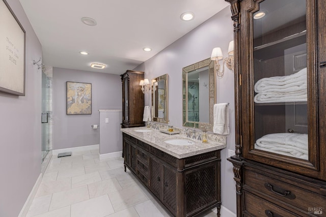 bathroom featuring vanity, a shower with shower door, and tile patterned floors