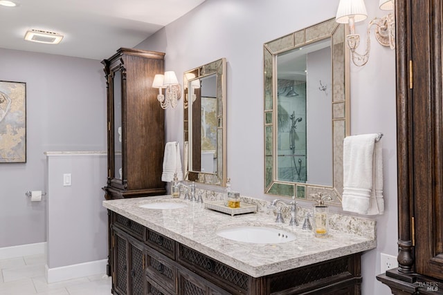 bathroom featuring vanity, tile patterned floors, and tiled shower