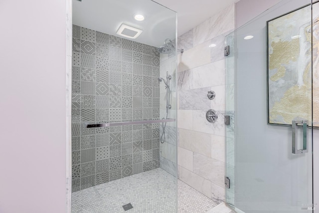 bathroom with a shower with door