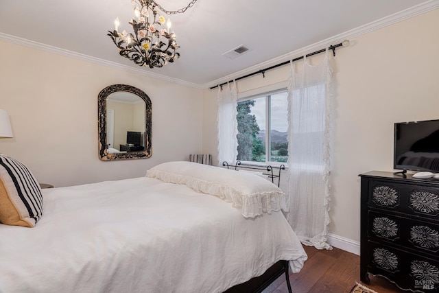 bedroom with dark wood-type flooring, crown molding, and a chandelier