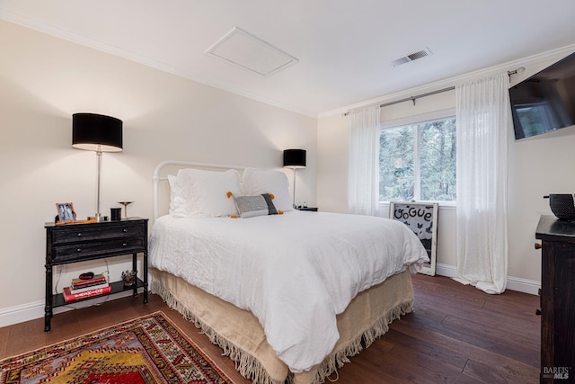 bedroom with crown molding and dark wood-type flooring