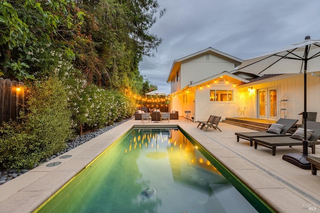 view of pool with a patio and french doors