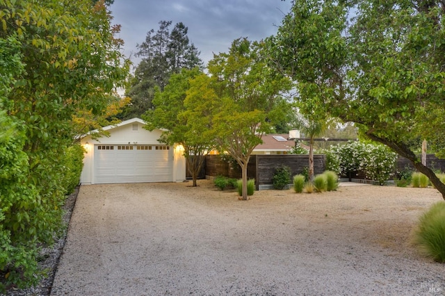 obstructed view of property with a garage