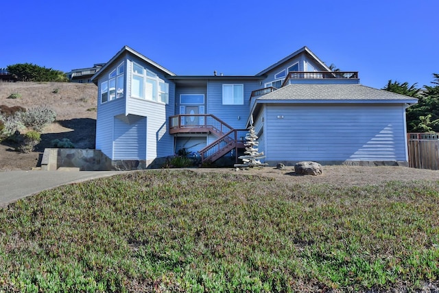back of house with a yard and stairway