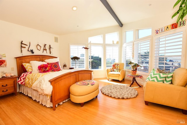 bedroom featuring recessed lighting, wood finished floors, and beam ceiling