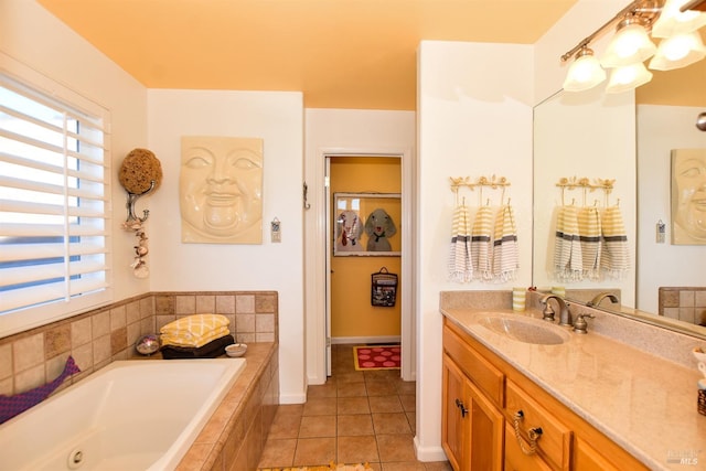 bathroom featuring vanity, a relaxing tiled tub, and tile patterned flooring