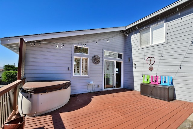 wooden deck with a hot tub