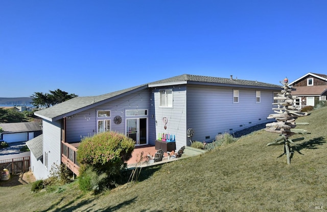 rear view of house featuring a patio area and a lawn