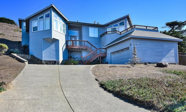 view of front of house with driveway, stairs, and a garage