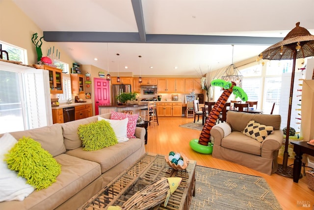living area featuring lofted ceiling with beams, recessed lighting, and light wood-style flooring