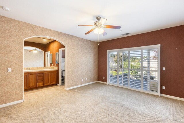 empty room with ceiling fan and light colored carpet