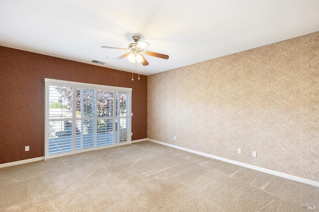 spare room with ceiling fan and carpet flooring