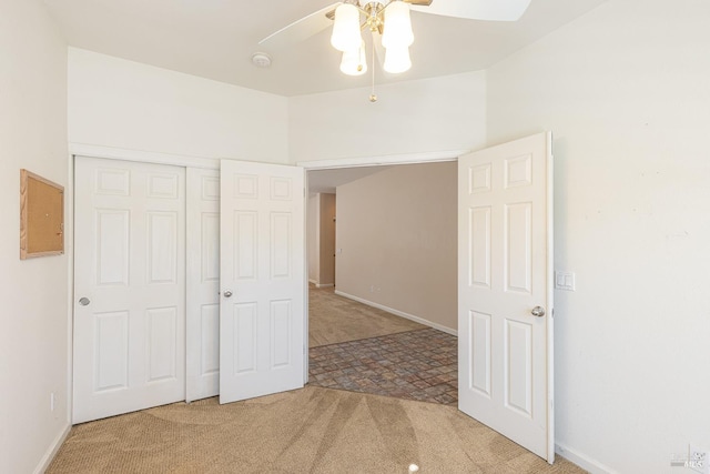 unfurnished bedroom with carpet flooring, a closet, and ceiling fan