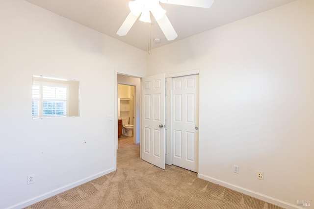 unfurnished bedroom with light colored carpet and ceiling fan