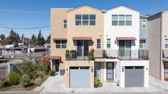 view of property with a balcony and a garage