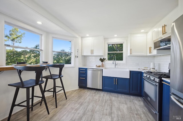 kitchen with appliances with stainless steel finishes, white cabinets, and light countertops