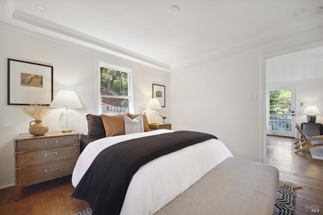 bedroom featuring dark wood-style flooring and crown molding