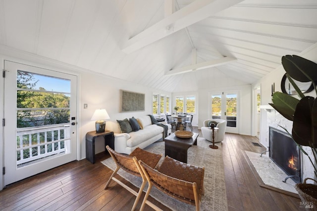 interior space with a fireplace with flush hearth, dark wood-style flooring, and lofted ceiling with beams