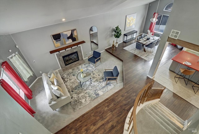 living room with a healthy amount of sunlight, a fireplace, and dark hardwood / wood-style floors