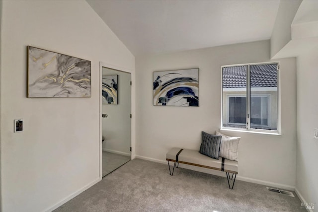 living area with light carpet and vaulted ceiling